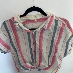 Red, blue, white, and yellow striped tee.